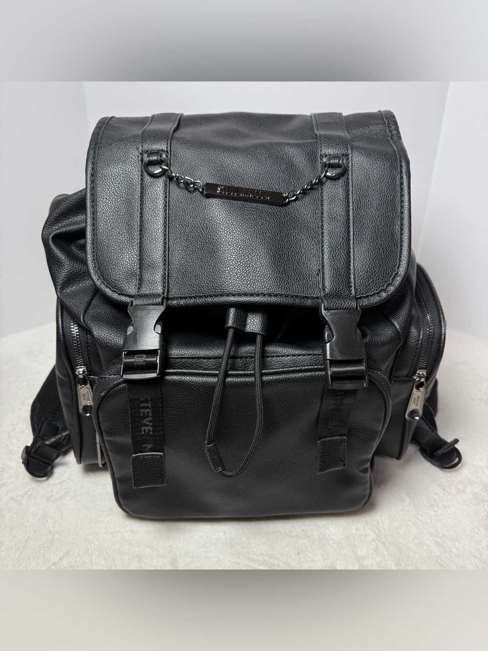 Steve Madden Black Pebbled Faux Leather Drawstring Backpack with Chain Trim